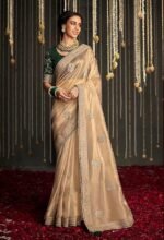 Shimmer Net Gold-coloured saree featuring an all-over heavy gold zari butta and sequence work on body decorated with border with contrast navy blue piping - Image 4